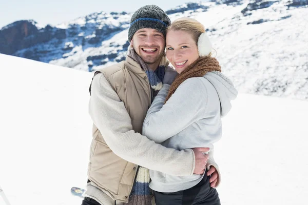 Loving couple in warm clothing on snowed landscape — Stock Photo, Image