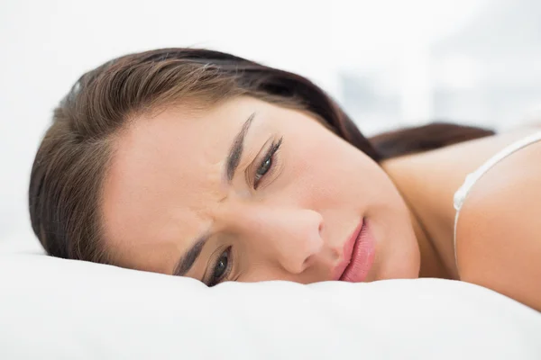 Pretty young woman resting in bed — Stock Photo, Image