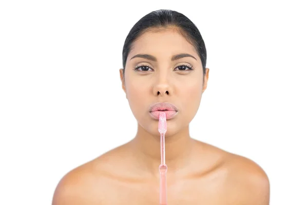 Frowning nude brunette holding toothbrush — Stock Photo, Image