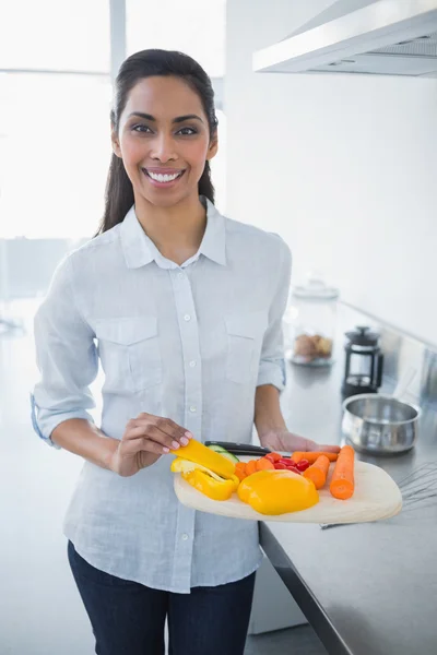 Beautiful proud woman showing vegetables smiling at camera — Stock Photo, Image