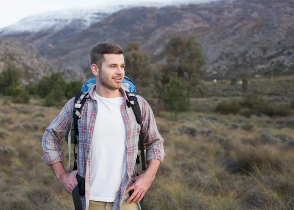 Hombre con mochila de pie en el paisaje forestal — Foto de Stock