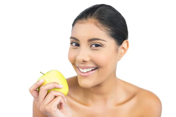 Smiling nude brunette holding green apple — Stock Photo, Image