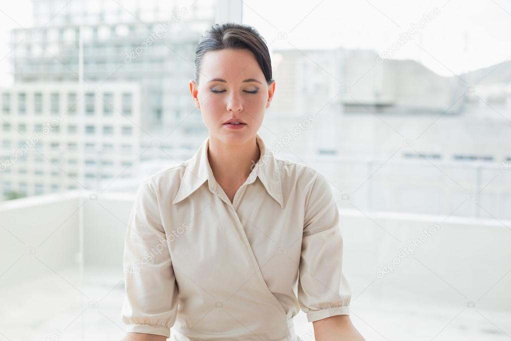 Businesswoman with eyes closed at office