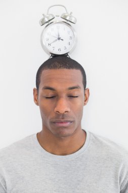 Man with an alarm clock on top of his head clipart