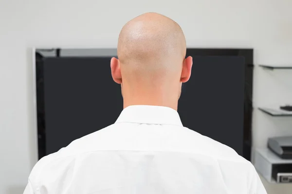 Extreme Close up of a bald man using computer