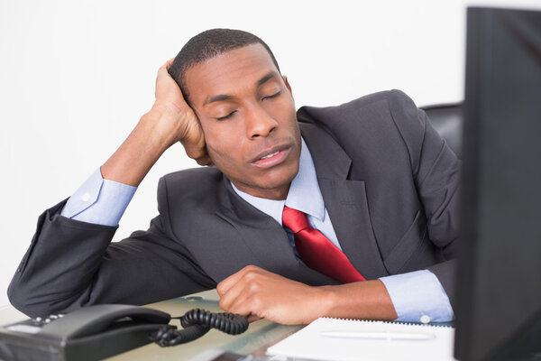 Afro businessman resting at desk over white background