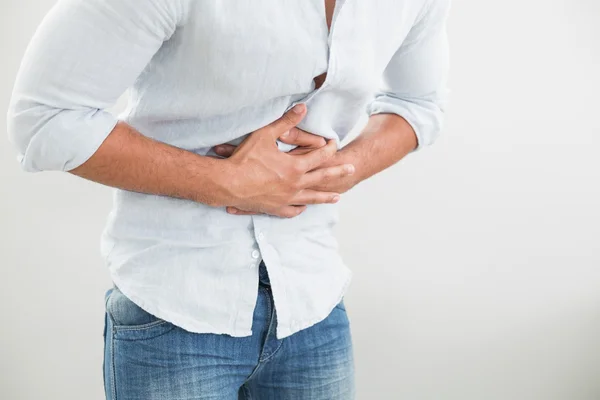 Mid section of man suffering from stomach pain — Stock Photo, Image