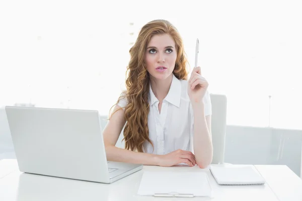 Beautiful businesswoman with laptop pointing upwards — Stock Photo, Image