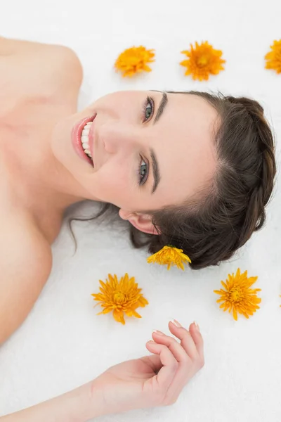 Beautiful young woman with flowers in beauty salon — Stock Photo, Image