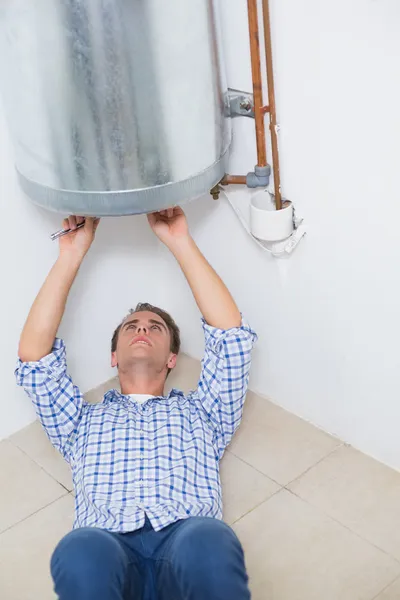 Technician servicing an hot water heater — Stock Photo, Image