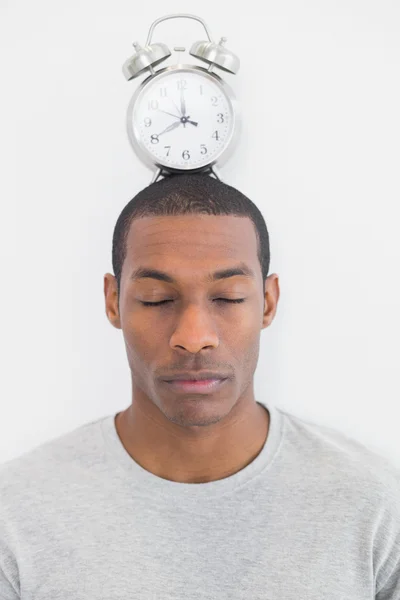 Man with an alarm clock on top of his head — Stock Photo, Image
