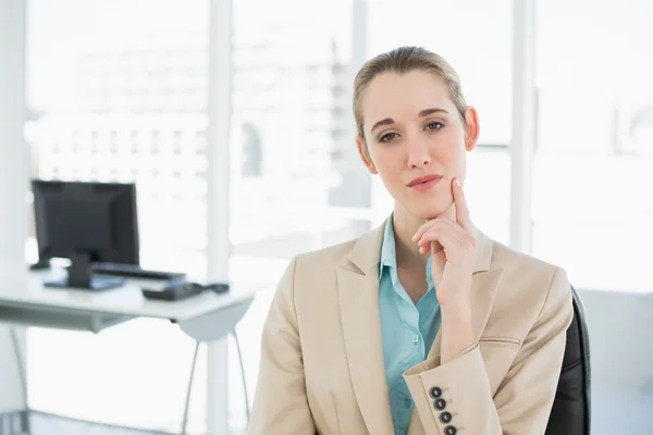 Nachdenkliche ruhige Geschäftsfrau auf ihrem Drehstuhl sitzend — Stockfoto