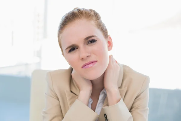 Close up of young businesswoman with neck pain — Stock Photo, Image