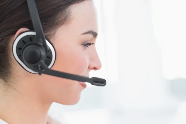 Close up side view of businesswoman wearing headset — Stock Photo, Image