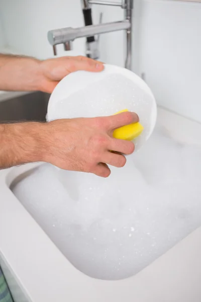 Man with reflection putting moisturizer on his face — Stock Photo, Image