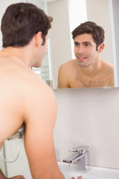 Rear view of tensed shirtless man at washbasin — Stock Photo, Image