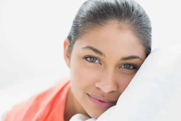 Pretty young woman lying in bed — Stock Photo, Image