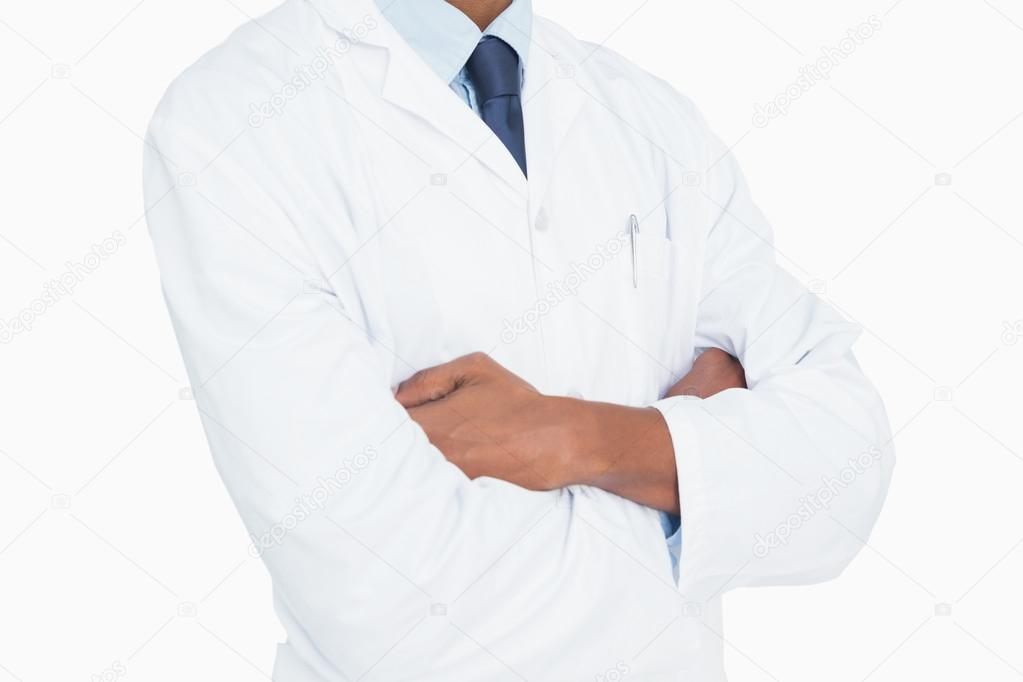 Close up mid section of a male doctor with arms crossed