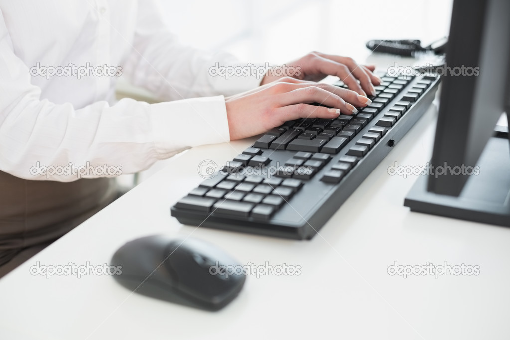 Close up of hands using computer keyboard