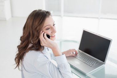 laptop ve cep telefonu kullanma office iş kadını