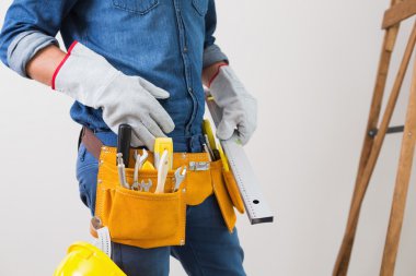 bir tamirciyle toolbelt ve kask ile orta kısmında