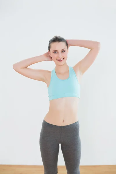 Sonriente mujer en forma de pie en el gimnasio —  Fotos de Stock