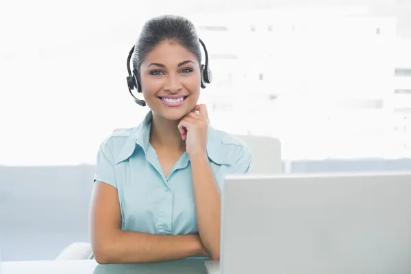 Businesswoman wearing headset in front of laptop — Stock Photo, Image