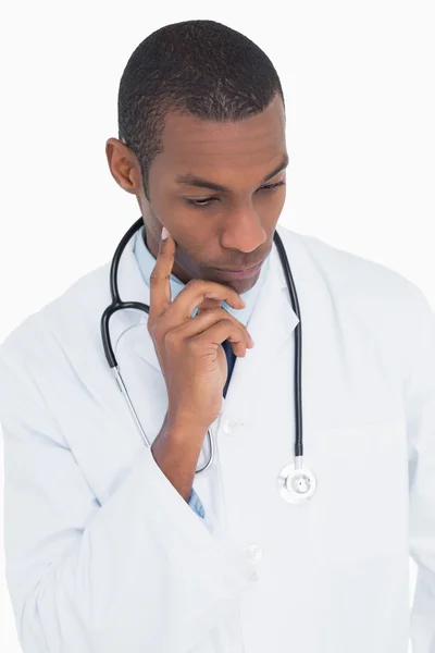 Serious thoughtful male doctor looking down — Stock Photo, Image