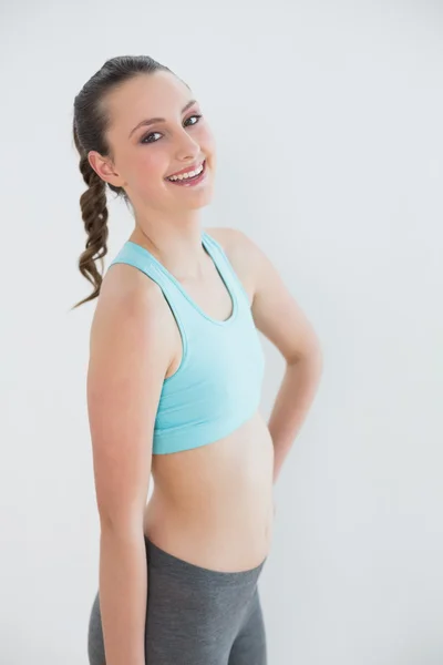 Portrait of a toned woman against wall — Stock Photo, Image