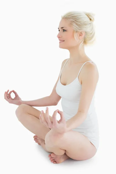 Full length portrait of toned woman sitting in lotus position — Stock Photo, Image