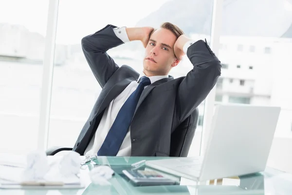 Worried young businessman at office desk — Stock Photo, Image