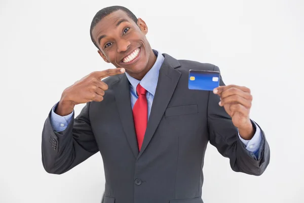 Cheerful young Afro businessman pointing at credit card — Stock Photo, Image