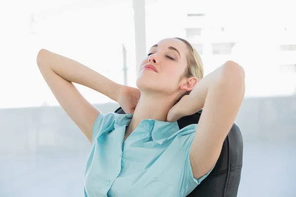 Beautiful peaceful businesswoman relaxing on her swivel chair — Stock Photo, Image