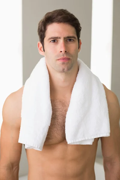 Shirtless man with towel around neck at home — Stock Photo, Image