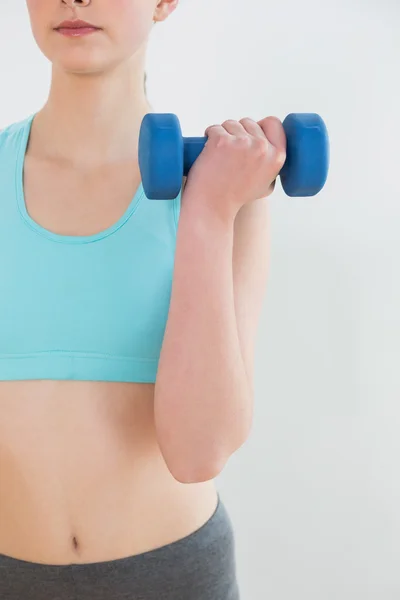 Woman with dumbbells at fitness studio — Stock Photo, Image