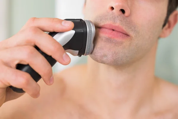 Extreme Close up of shirtless man shaving with electric razor — Stock Photo, Image