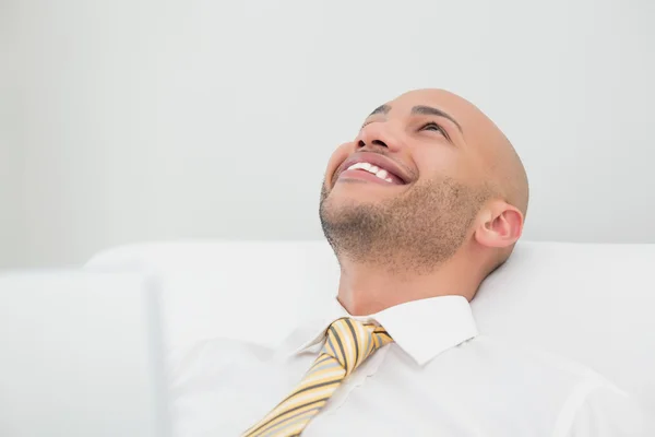 Close up of smiling elegant young businessman looking up — Stock Photo, Image