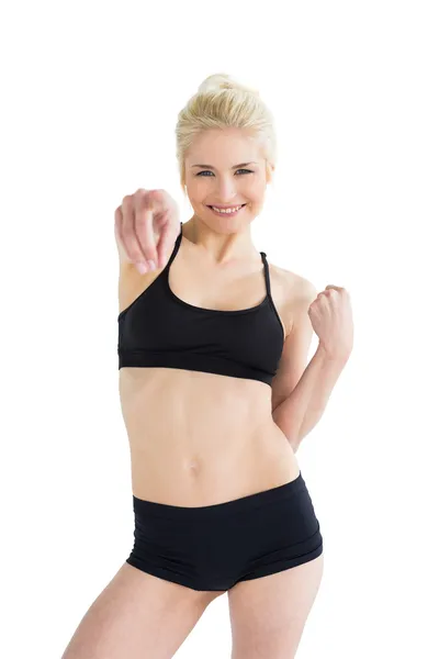 Beautiful sporty woman pointing towards the camera — Stock Photo, Image