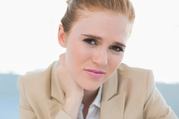 Close up of young businesswoman with neck pain — Stock Photo, Image