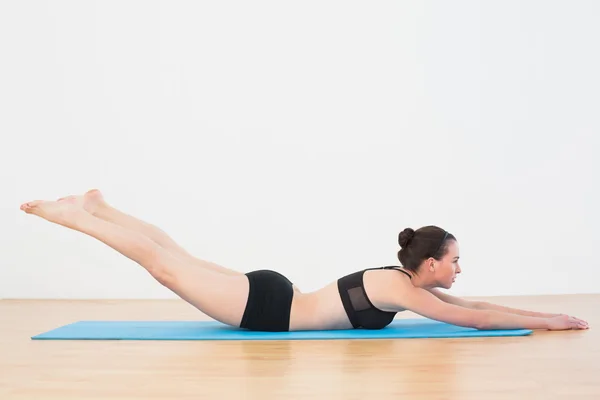 Sporty young woman doing the Locust Posture — Stock Photo, Image