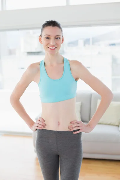 Femme tonique avec les mains sur les hanches dans le studio de fitness — Photo