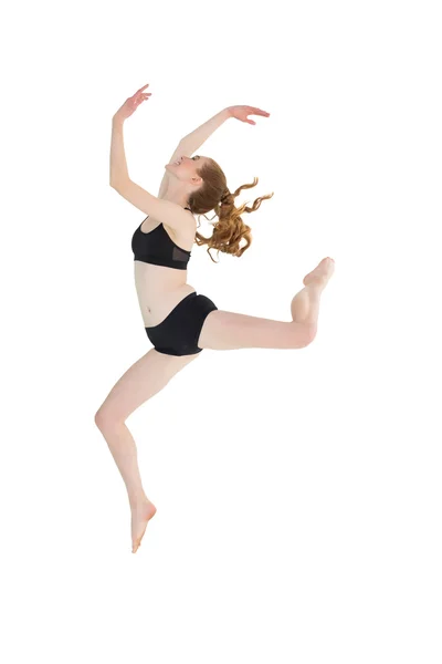 Longitud completa de una joven deportista saltando — Foto de Stock
