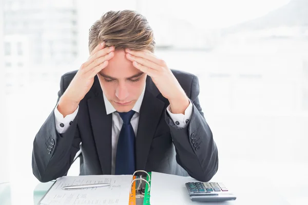 Worried businessman with head in hands at office desk — Stock Photo, Image