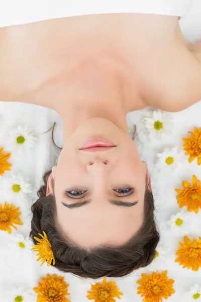 Beautiful young woman with flowers in beauty salon — Stock Photo, Image