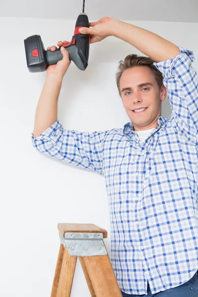 Handyman using cordless drill to the ceiling — Stock Photo, Image