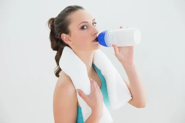 Vrouw met water fles tegen muur passen — Stockfoto