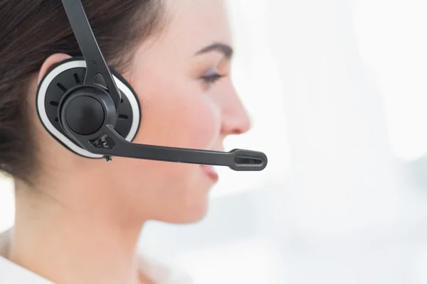 Close up side view of businesswoman wearing headset — Stock Photo, Image