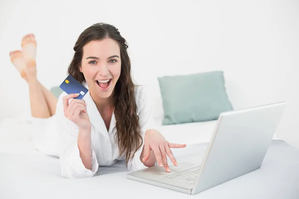 Portrait of a cheerful young woman resting in bed — Stock Photo, Image