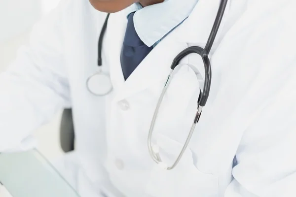 Mid section of doctor in lab coat and with stethoscope — Stock Photo, Image