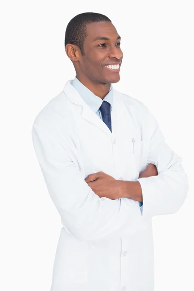 Smiling male doctor standing with arms crossed Royalty Free Stock Images